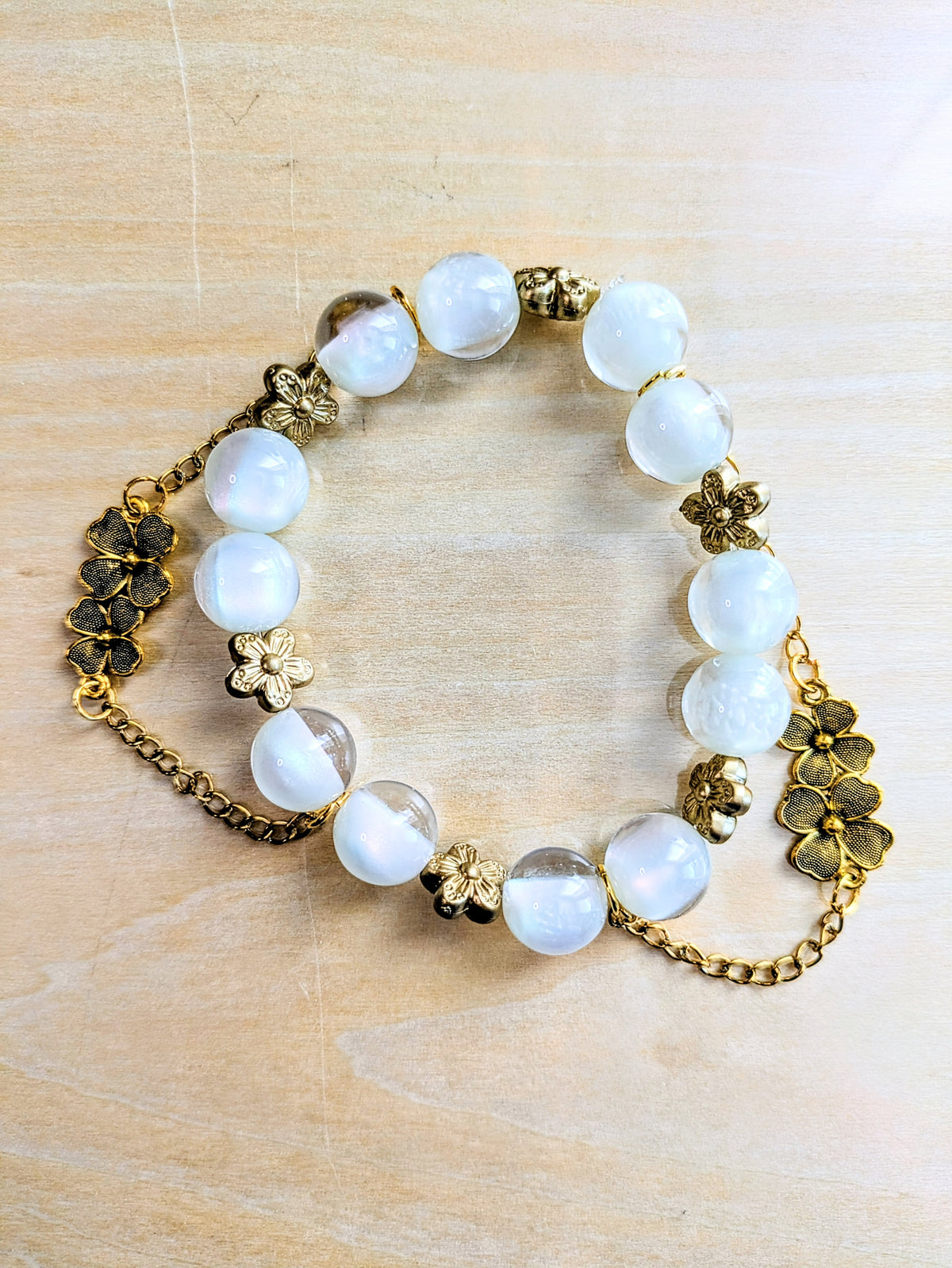 Clear White Cats Eye Beads and Golden Flower Charm Bracelet