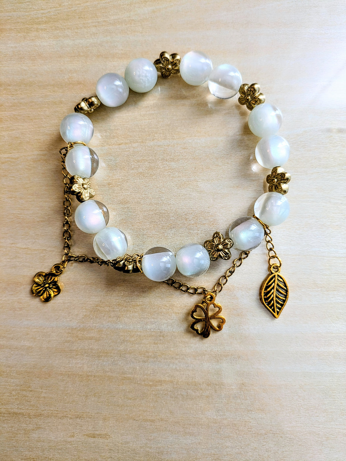 White Cats Eye with Gold Plated Floral Charmed Bracelet
